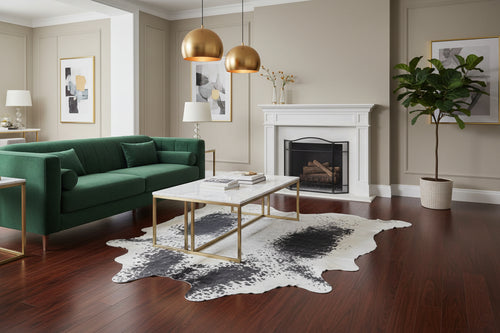 Cowhide rug with black spots on a white background