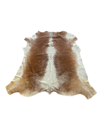 Brown and white cowhide rug on a white background
