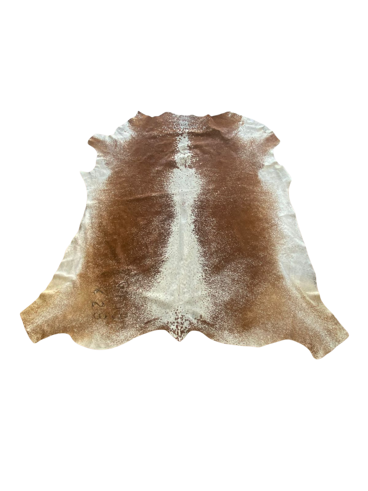 Brown and white cowhide rug on a white background