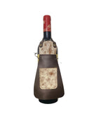 Wine bottle in a decorative leather holder