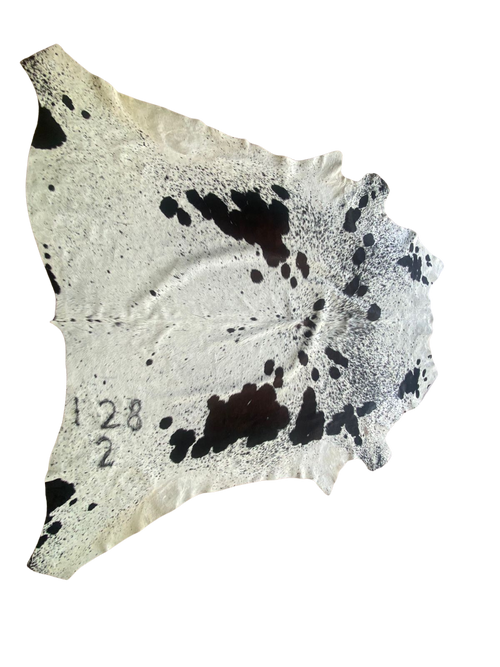 Cowhide with black spots on a white background