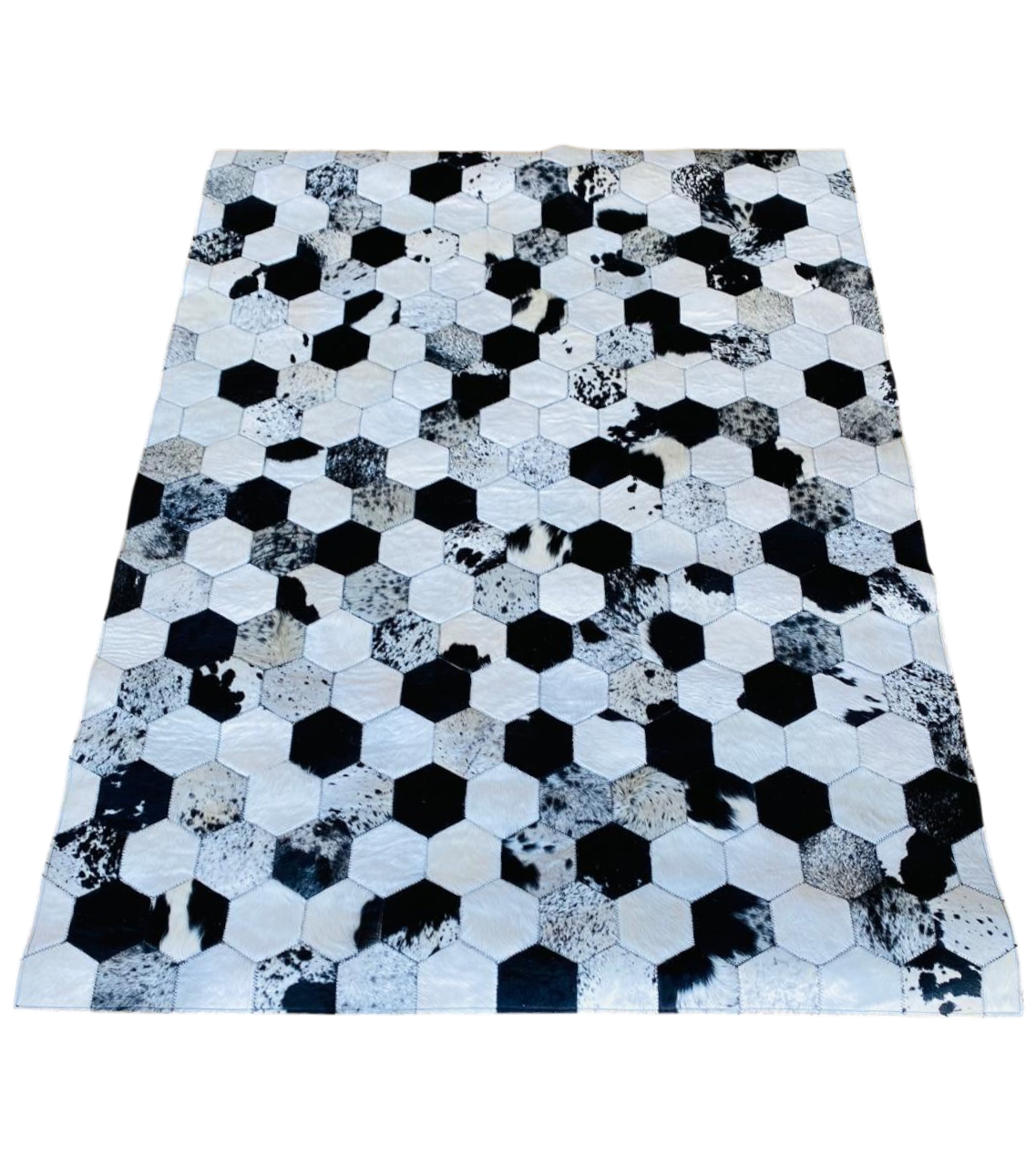 Hexagonal patterned rug with black, white, and grey colours 