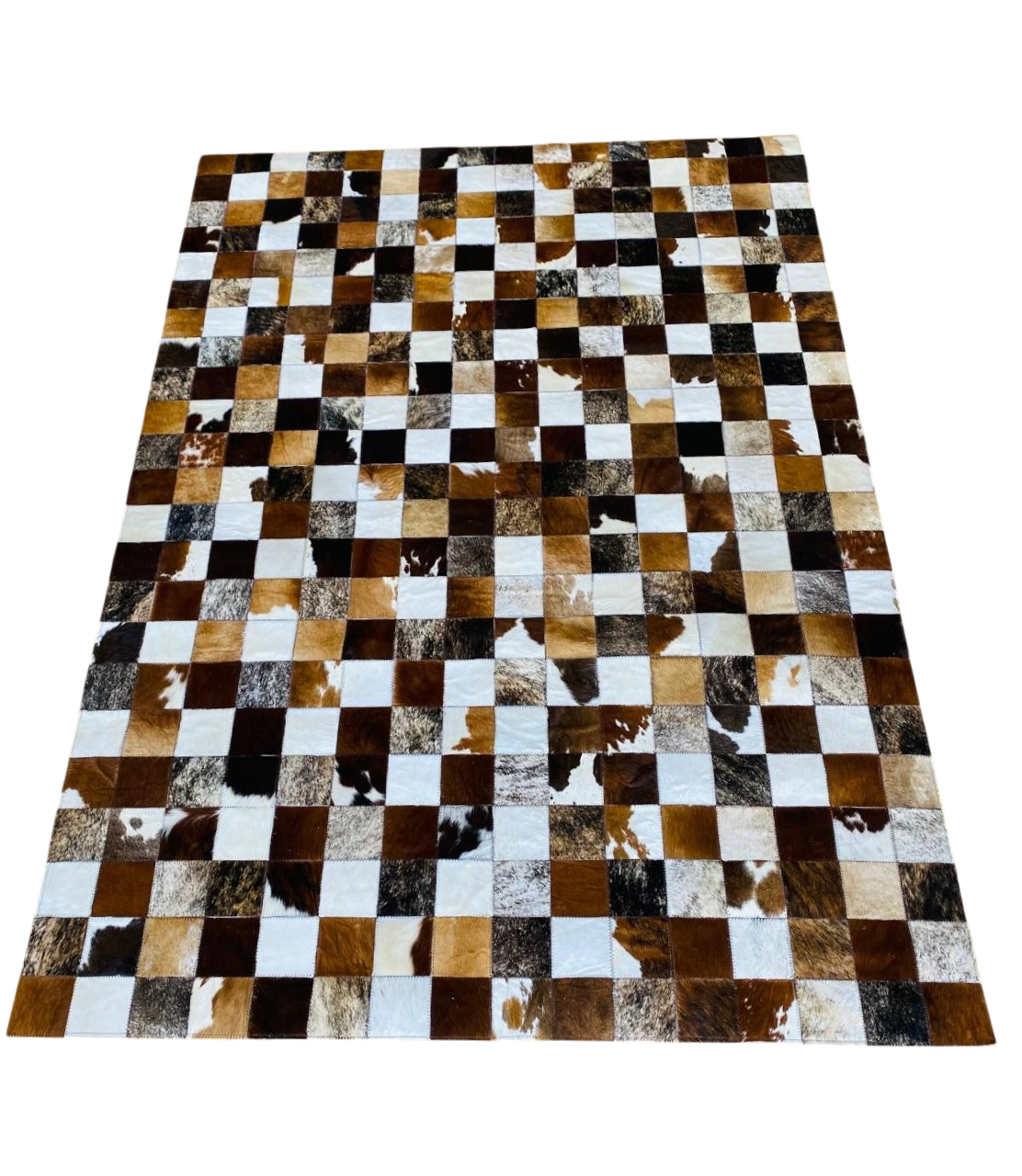 square patterned rug with brown, black, and white patches 