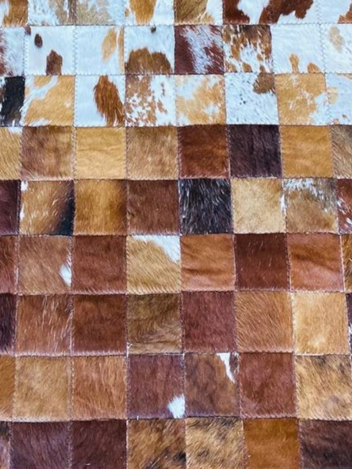 Checkered pattern of brown, beige, and white squares
